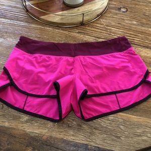 Size 10, Lululemon speed short.  Mostly fuchsia with maroon top and black trim